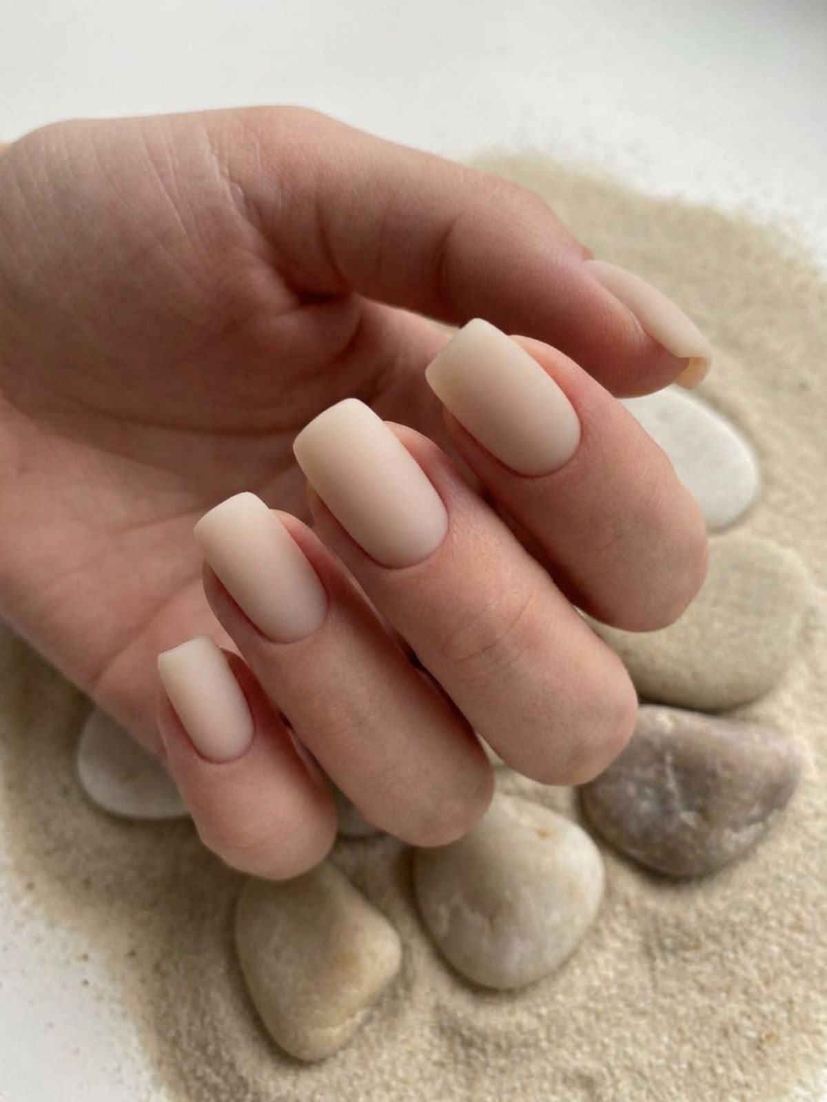 A modern matte velvet finish on short squoval beige milky nails. Beige and Milky White Nail Ideas - A modern matte velvet finish on short squoval beige milky nails.