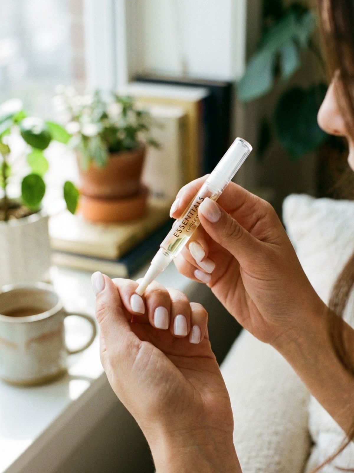 applying-cuticle-oil-healthy-nails Minimal Nails Without Extensions - Daily hydration is essential for maintaining the clean minimal aesthetic.