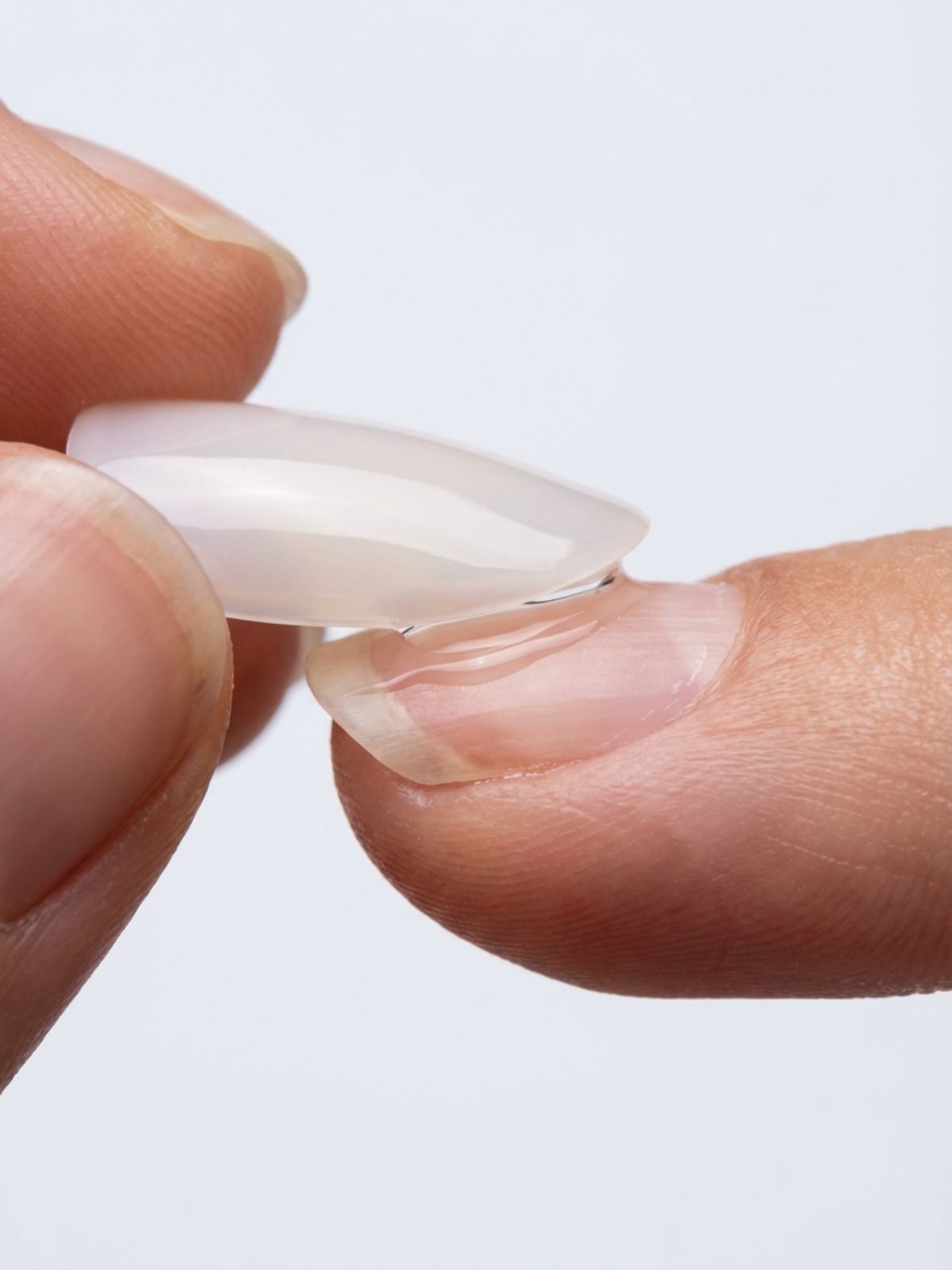 How to Fix Press-On Nails That Fall Off - Applying at a 45-degree angle pushes out air bubbles for a secure bond.