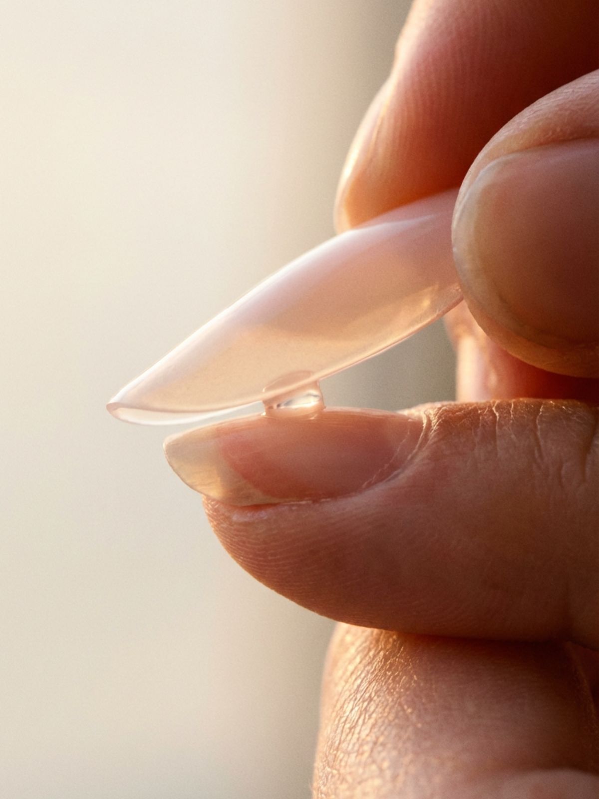 applying-press-on-nails-45-degree-angle How to Choose Press-On Nail Size - Applying at a 45-degree angle pushes out air bubbles for a secure, vacuum-like seal.