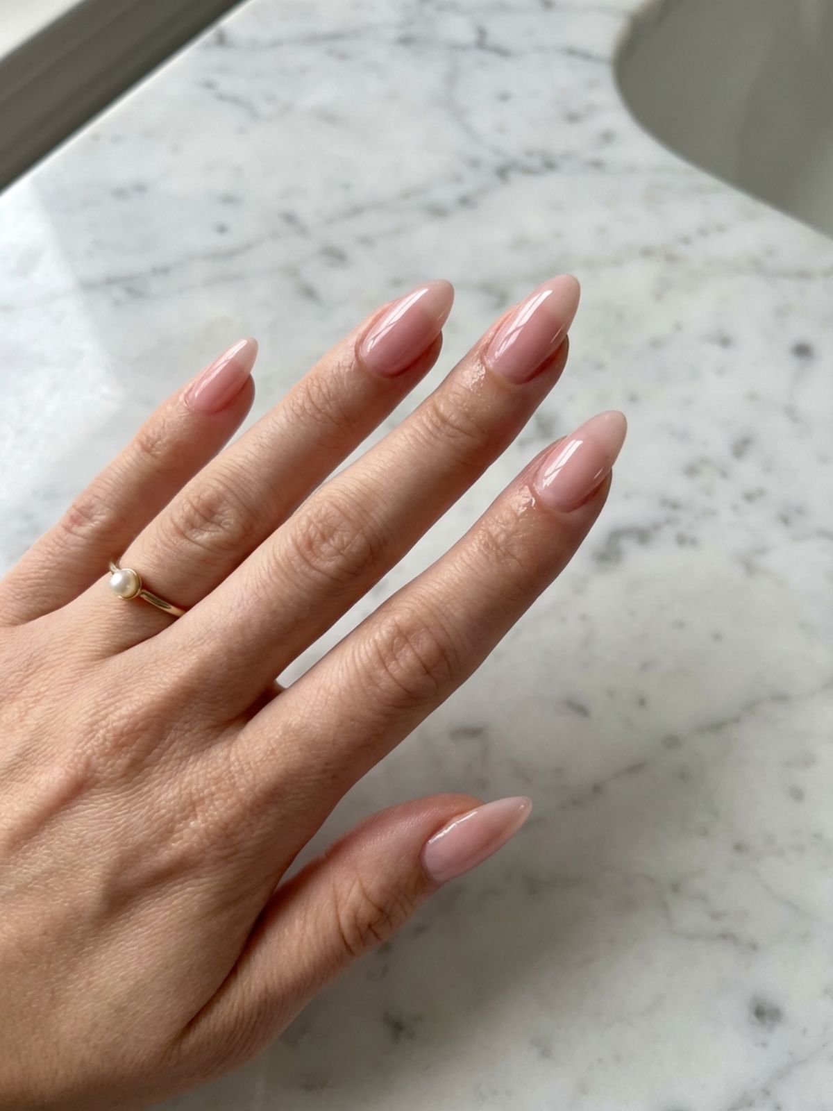 Classic sheer blush nails on an almond shape for timeless elegance. Soft Pink Minimal Nail Ideas - Classic sheer blush nails on an almond shape for timeless elegance.