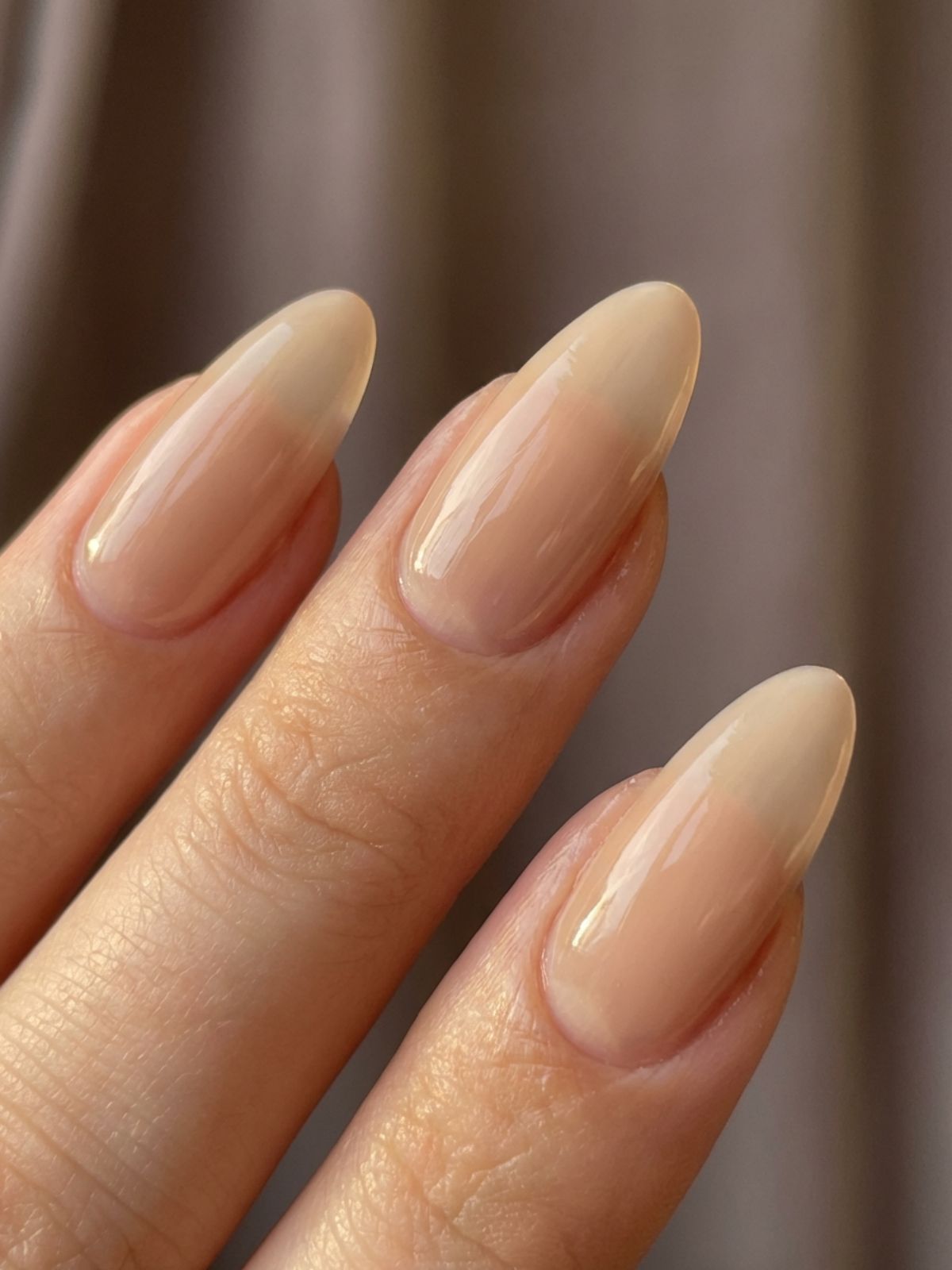 Close-up detail showing the semi-translucent texture of beige milky white nails. Beige and Milky White Nail Ideas - Close-up detail showing the semi-translucent texture of beige milky white nails.