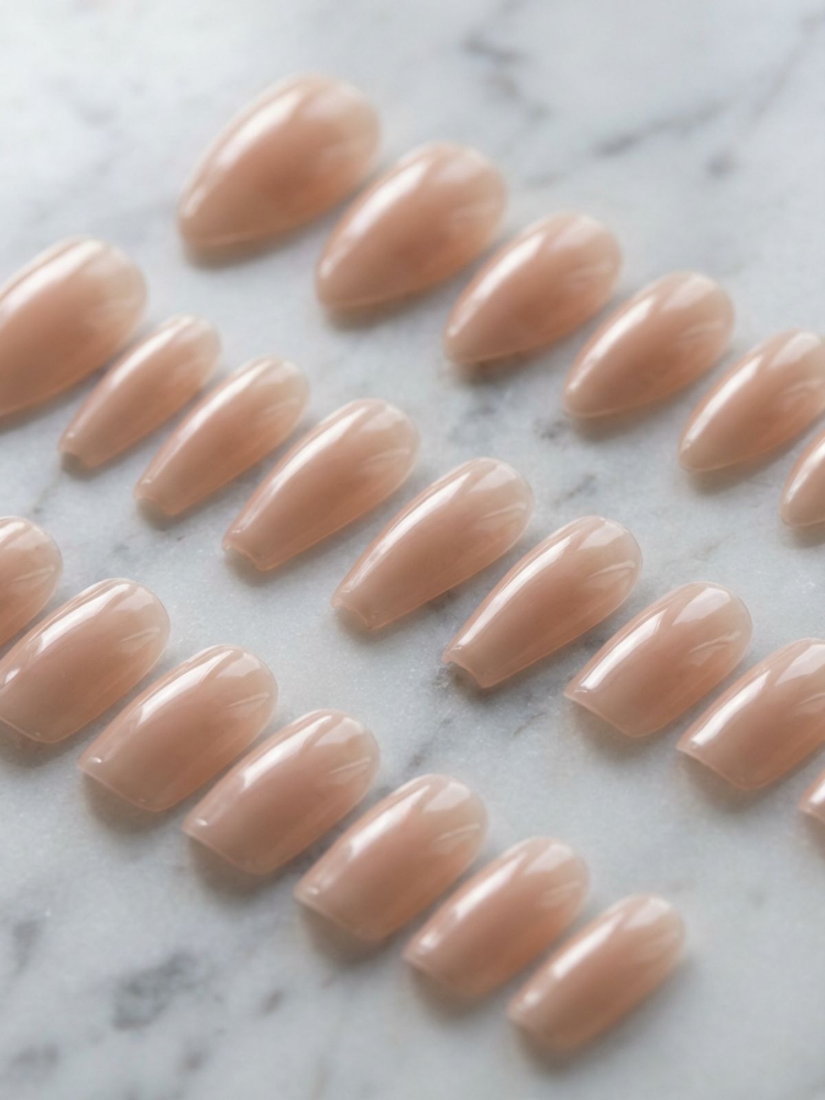 Press-On Nails Care Tips - Modern press-ons offer structural integrity and varied shapes to mimic natural growth.