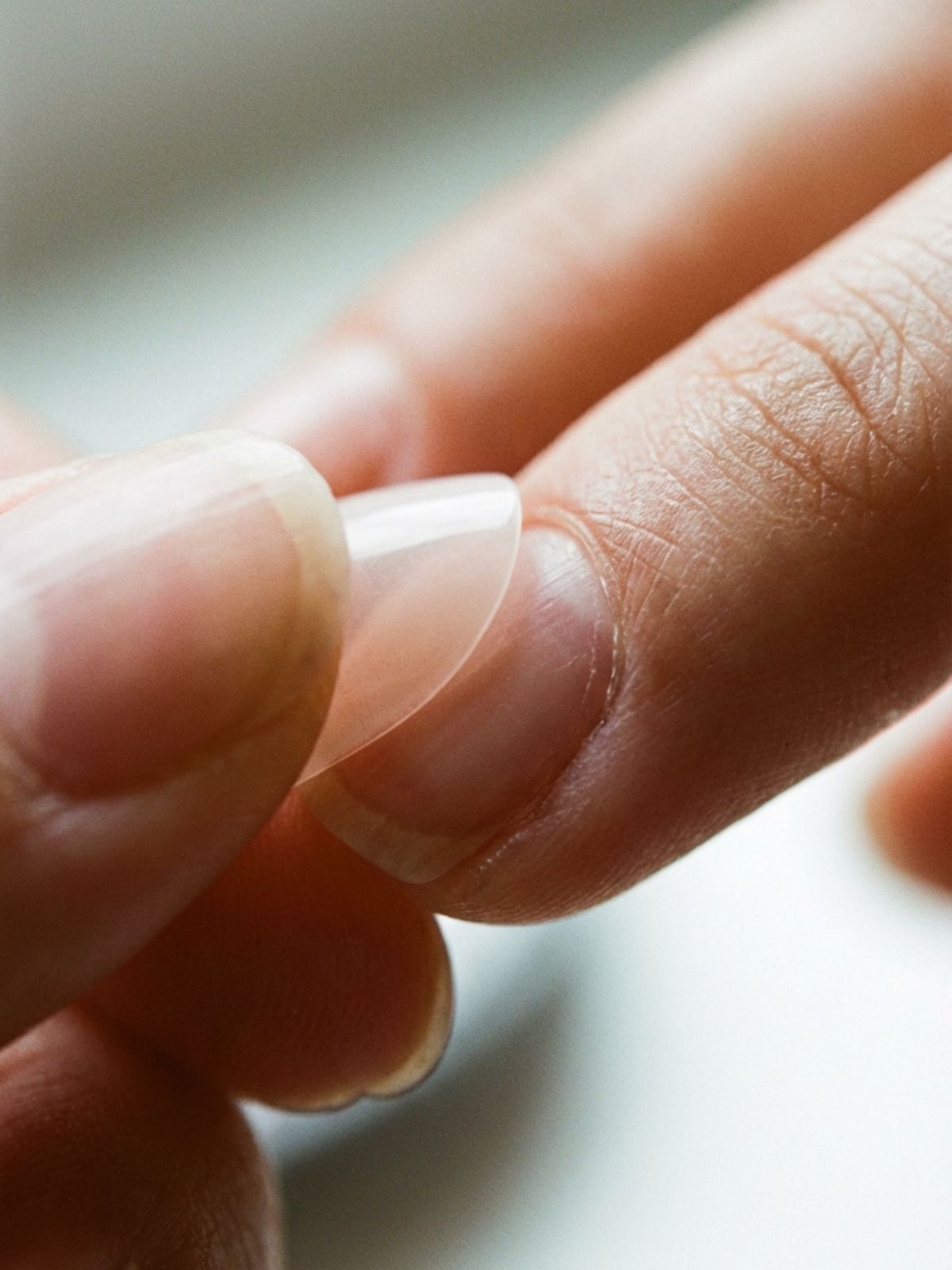 applying-natural-looking-press-on-nails Best Minimal Press-On Nails Under $15 - The key to a believable faux manicure lies in a seamless, gap-free cuticle fit.