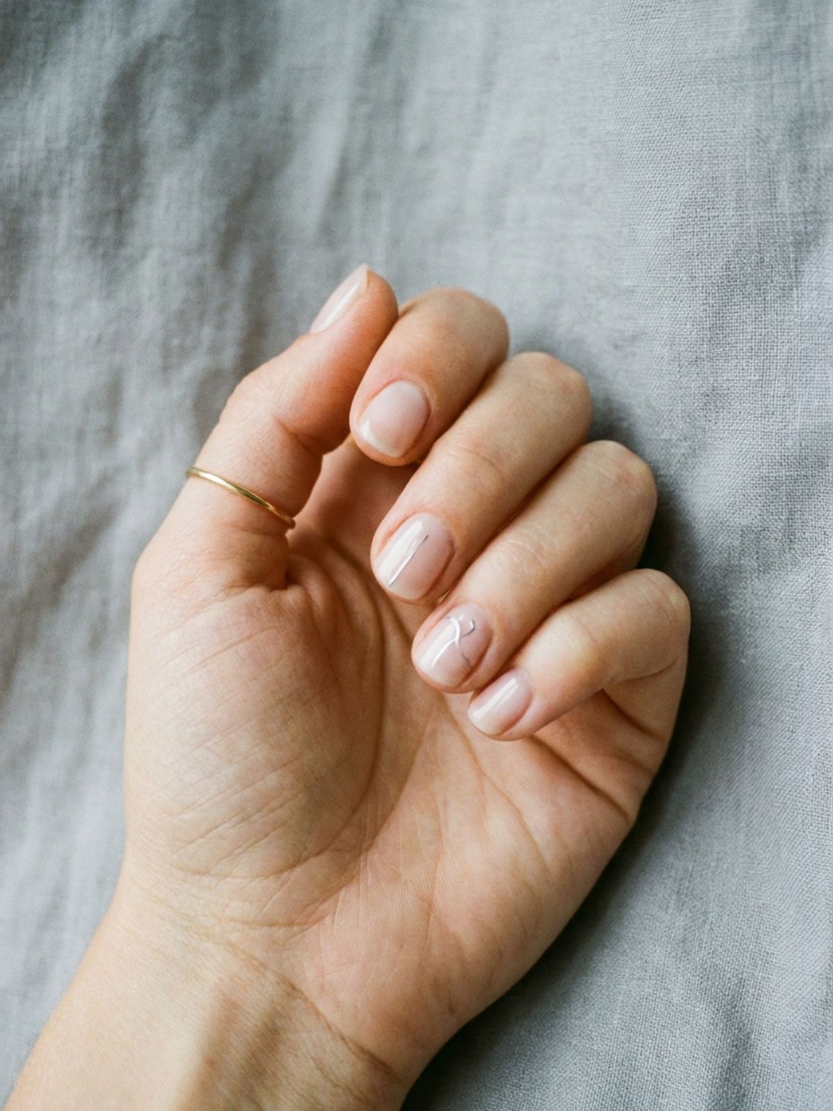 finished-minimalist-manicure-grey-background Best Minimal Press-On Nails Under $15 - A sophisticated, minimal manicure fits seamlessly into any lifestyle, no salon required.