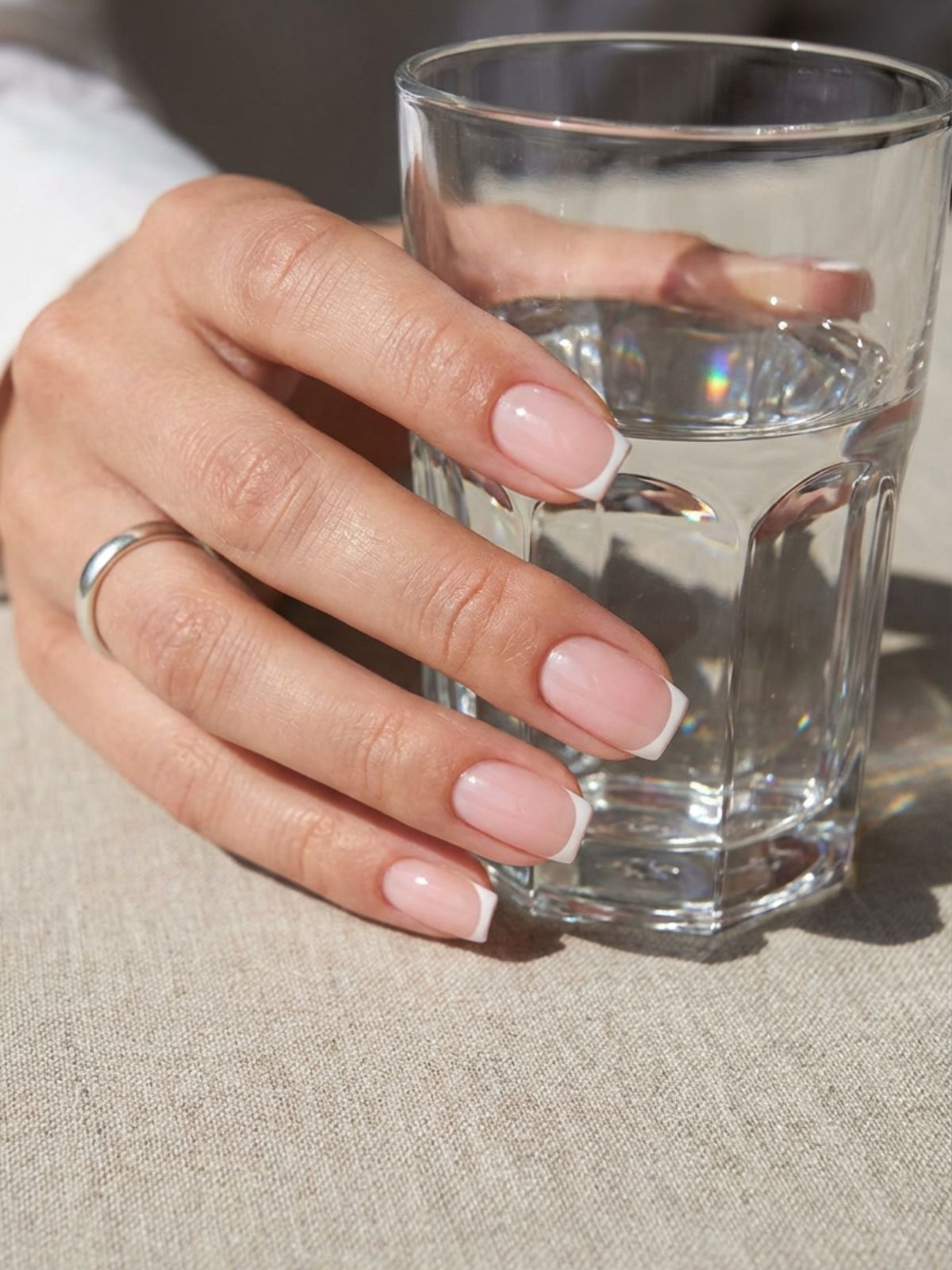 micro french tip squoval nails Minimal Nails That Look Good on Camera - A modern micro-French tip adds barely-there structure to a classic nude base.