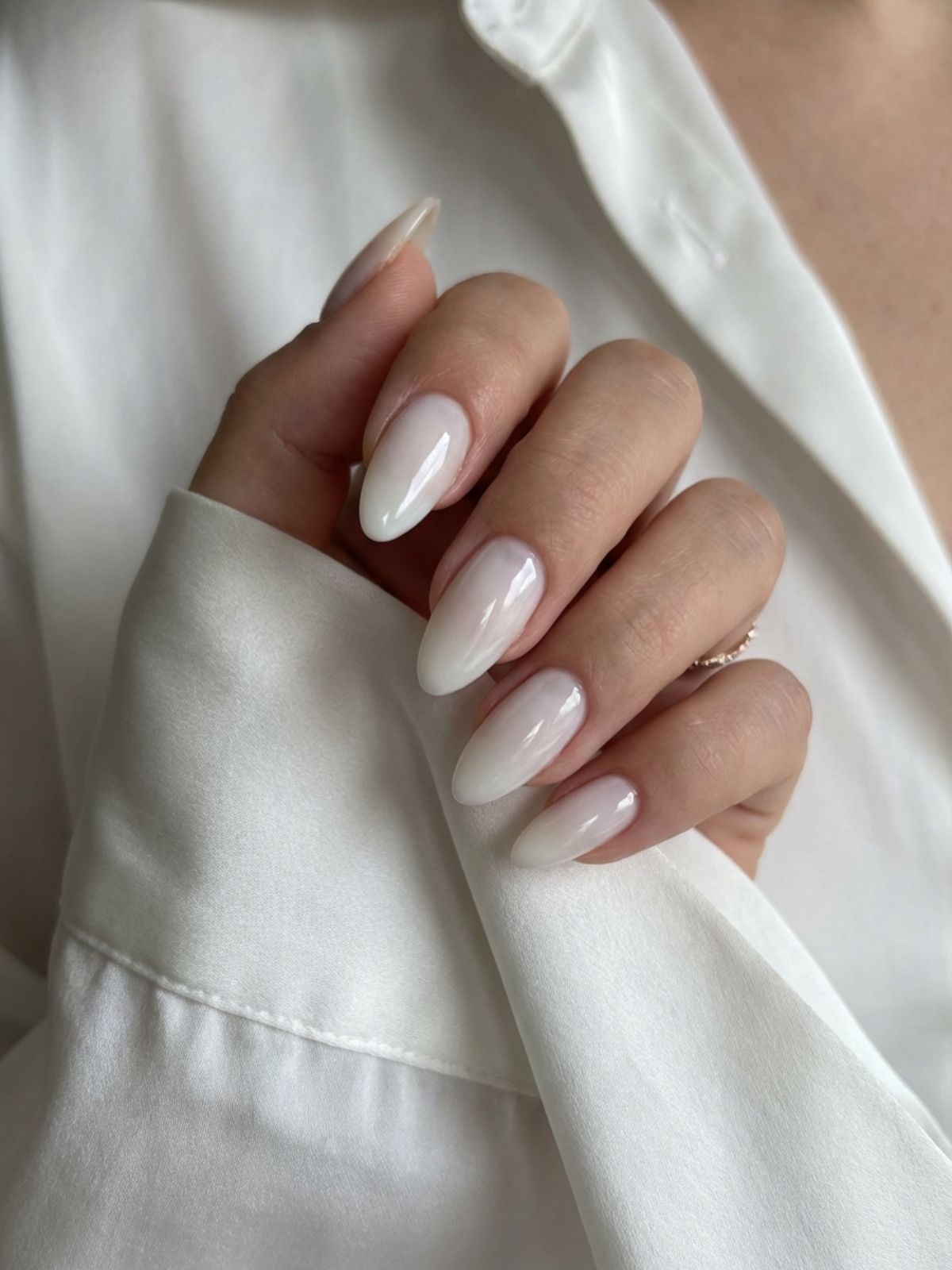 modelones-milky-white-almond-nails Best Minimal Press-On Nails Under $15 - Milky white almond nails offer a trendy, glazed finish that softens the hands.