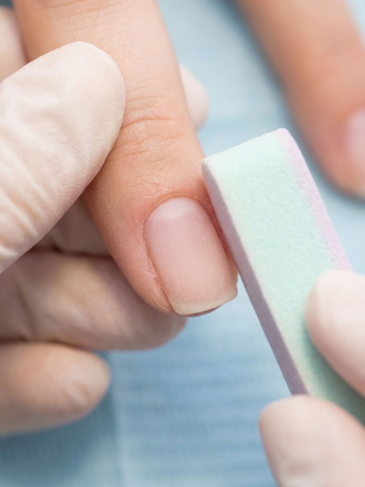 Press-On Nails vs Acrylic Nails - Removing surface shine is the critical 'dry prep' step that prevents premature lifting.