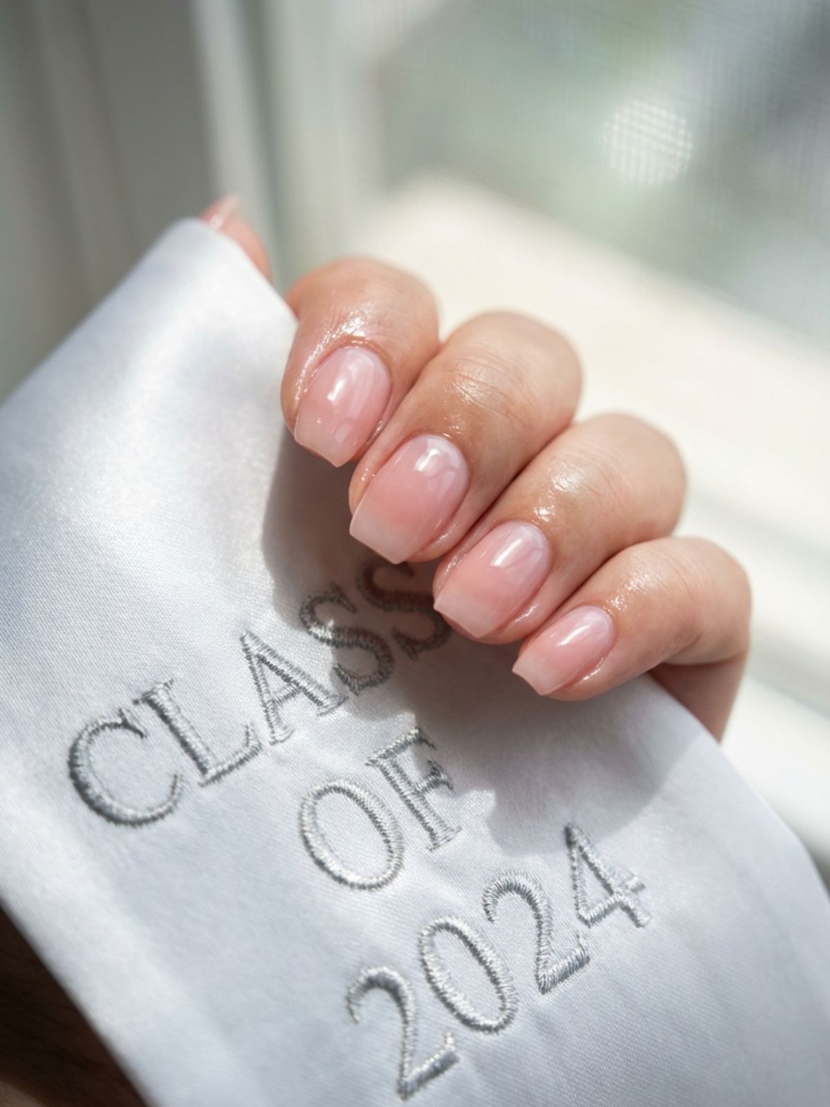 Minimal Nails for Graduation - The ultimate 'clean girl' aesthetic: sheer pink nails that look healthy and hydrated.